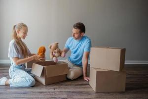 Happy father with daughter have fun in their new home. Family enjoy their moving day photo