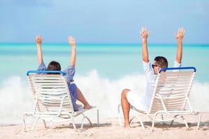 Couple relax on a tropical beach at Maldives photo