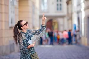 mujer joven con un mapa de la ciudad en la ciudad. chica turística de viaje con mapa en viena al aire libre durante las vacaciones en europa. foto