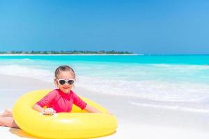 Adorable little girl having fun on the beach photo