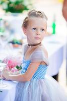 adorable niñita con un vestido increíble en una ceremonia de boda al aire libre foto