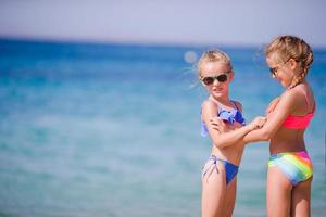 Adorable little girls during summer vacation. Kids enjoy their travel in Mykonos photo