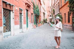 Travel tourist woman with map in Rome outdoors during holidays in Europe. photo