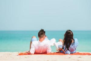 Young couple on white beach during summer vacation. photo