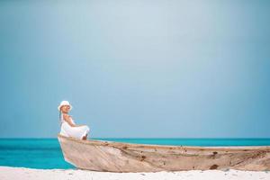 Adorable little girl have fun at tropical beach during vacation photo