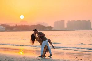 Young couple on white beach during summer vacation. photo