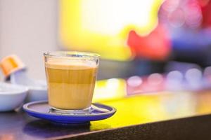 Cup of coffee on bar counter in the store photo