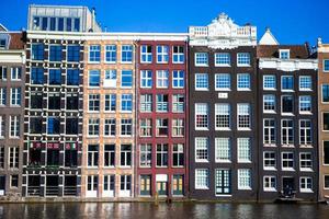 Traditional dutch buildings on canal in Amsterdam, Netherlands photo