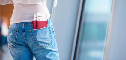 Two passports and boarding pass at airport in woman pocket photo