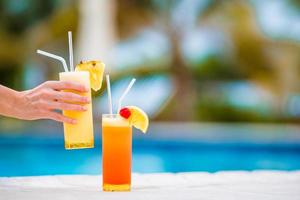 Two tasty cocktails on tropical white beach photo