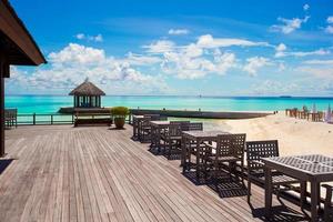 Summer empty outdoor cafe on shore at exotic island in indian ocean photo