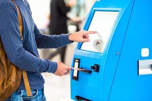 Closeup display at self-service transfer machine, doing check-in for flight or buying airplane tickets at airport photo