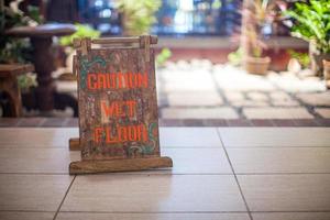 Sign at the small hotel-wet floor caution photo