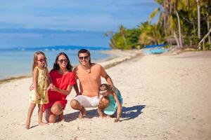 Beautiful family of four have fun on the beach in Philippines photo