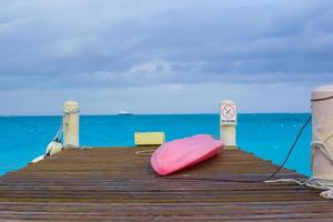 Pier with boat on a tropical beach photo