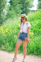 Young woman in hat in the park outdoors photo
