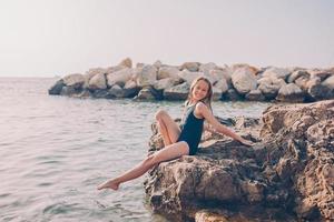 Cute little girl at beach during summer vacation photo