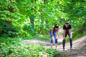 Fitness healthy lifestyle of young couples training for marathon run outside in park photo