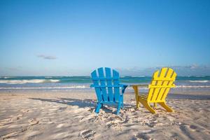 Beach wooden colorful chairs for vacations on tropical beach in Tulum photo