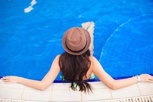 Top view of a young woman wearing hat in the pool photo