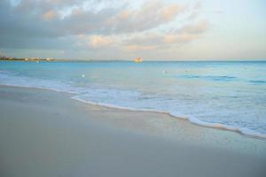 Stunning beautiful sunset on an exotic caribbean beach photo