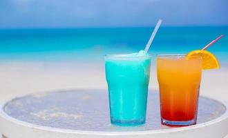 Two tasty cocktails on the white sandy beach photo