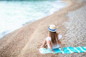 Cute little girl at beach during summer vacation photo