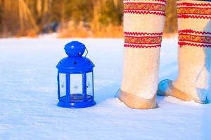 Closeup of beautiful vintage blue Christmas lantern on the snow photo