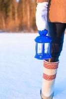 Closeup of beautiful vintage blue Christmas lantern on the snow photo