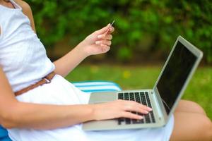 Young woman with laptop during summer vacation photo