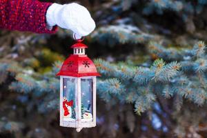 Closeup of hand holding beautiful vintage Christmas lantern photo