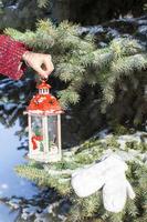 Closeup of hand holding beautiful vintage Christmas lantern photo