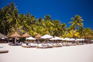 Tropical white sunny beach in beautiful exotic resort photo