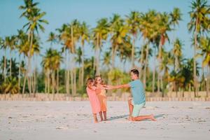 Father and little kids on the beach photo