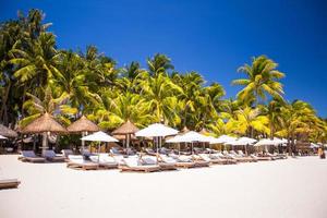 Tropical white sunny beach in beautiful exotic resort photo