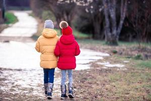 Adorable little girls outdoors in the forest photo