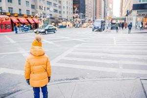 Adorable little girls have fun on Times Square in New York City photo