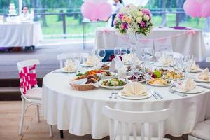 Wedding white banquet tables prepared for celebration photo