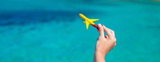 Small homemade plane on background of turquoise sea photo
