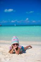 Portrait of adorable little girl on summer vacation at white beach photo