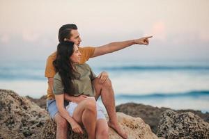 Young couple on the beach vacation in Florida at sunset photo