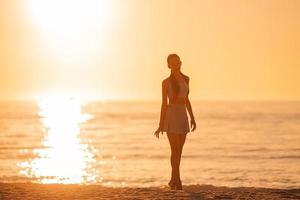 Happy young girl enjoy tropical beach vacation photo