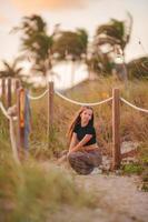 Cute teen beautiful girl having fun on tropical seashore photo