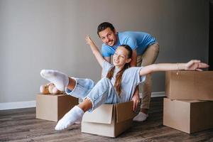 Family have fun on moving day in their new home photo
