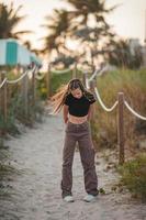 Cute teen beautiful girl having fun on tropical seashore photo