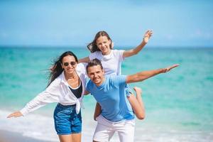 Family of three on the beach having fun together photo