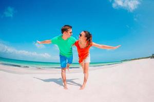Young couple on white beach during summer vacation. photo