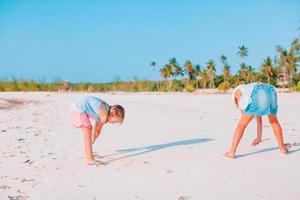 Little girls on the beach during summer vacation photo