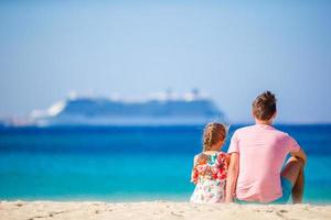 Happy dad and little girl on beach summer vacation photo