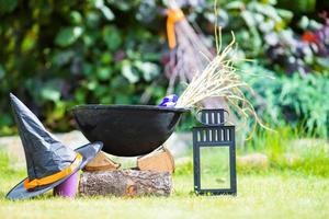 Halloween accessories pot, hat, broom, candle, garlic and flashlights photo